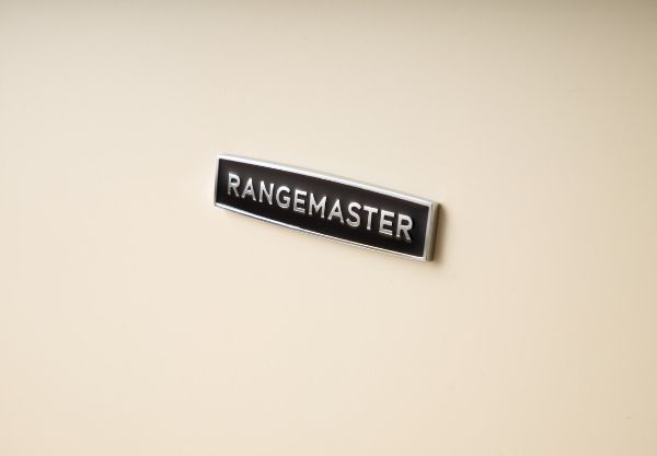 Rangemaster 14677 Classic Deluxe 100 Induction Range Cooker in Pale Cream with Chrome Trim - CLDL100EIPPCR/CM1_badge